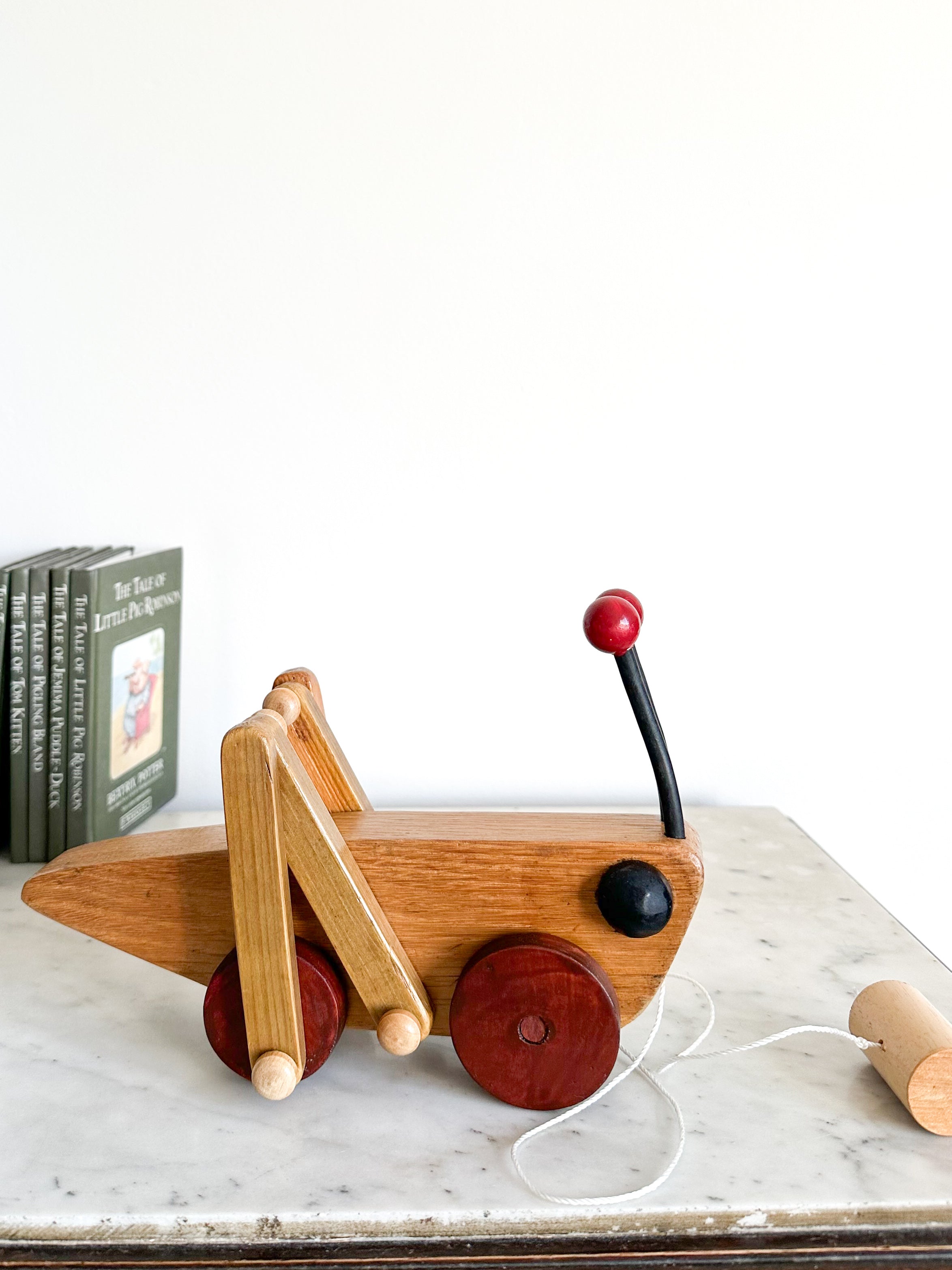 Vintage handmade wooden grasshopper pull along toy