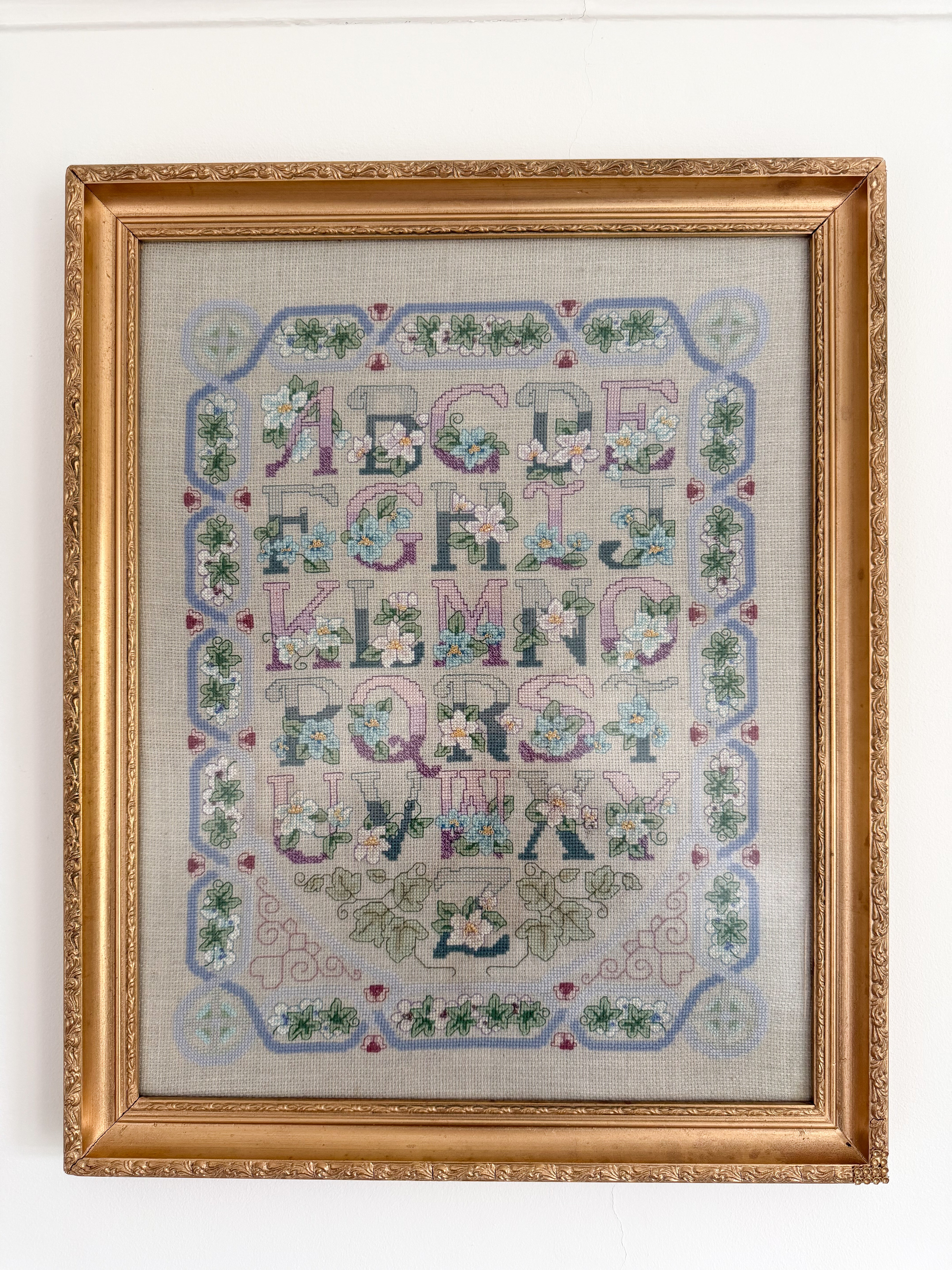 Vintage framed alphabet ABC floral cross stitch sampler in lilac and pastels