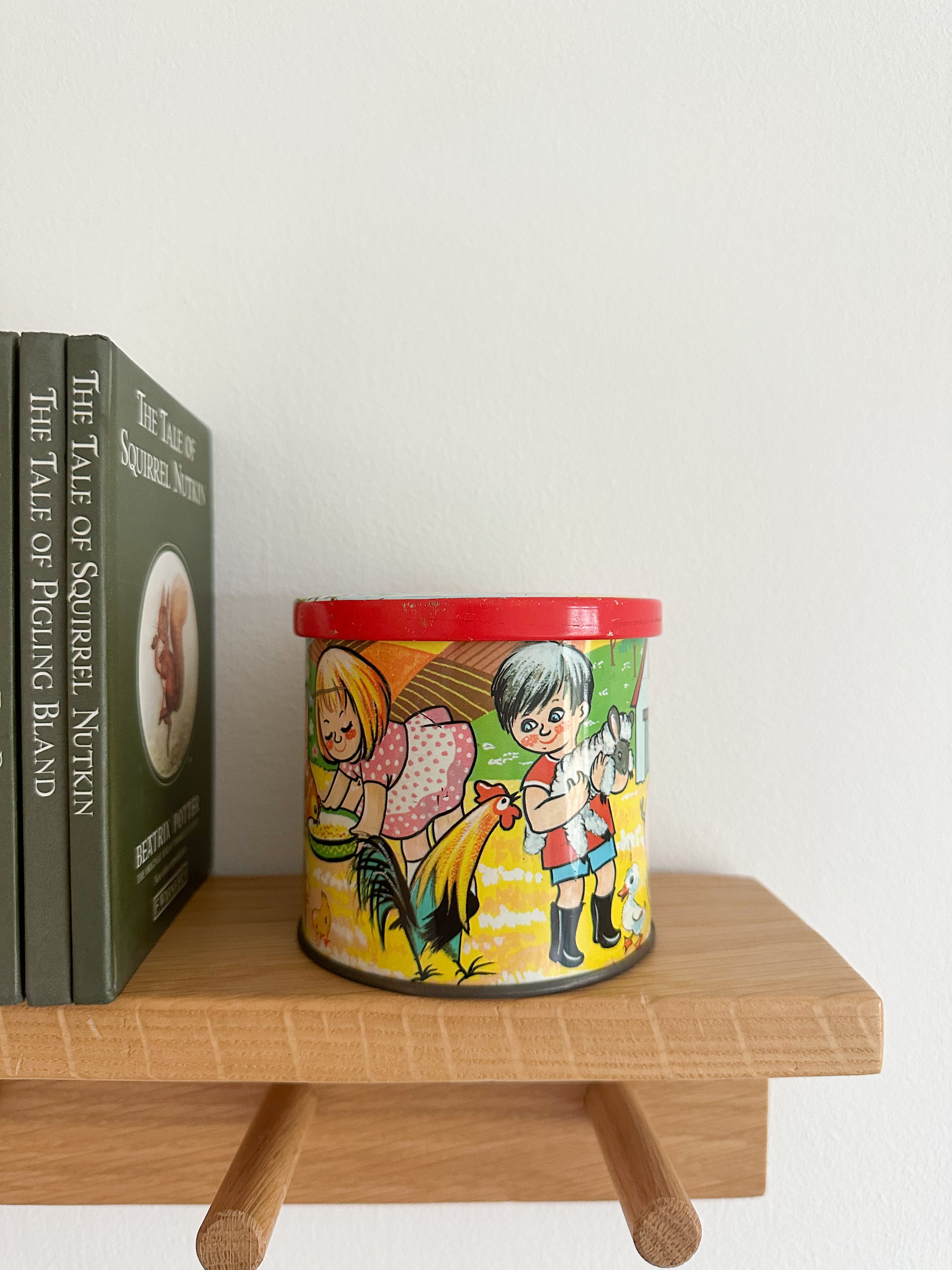 Vintage 1950s children’s illustrated graphic tin feat. girls and boys with farm animals, by Bluebird Toffee - Moppet