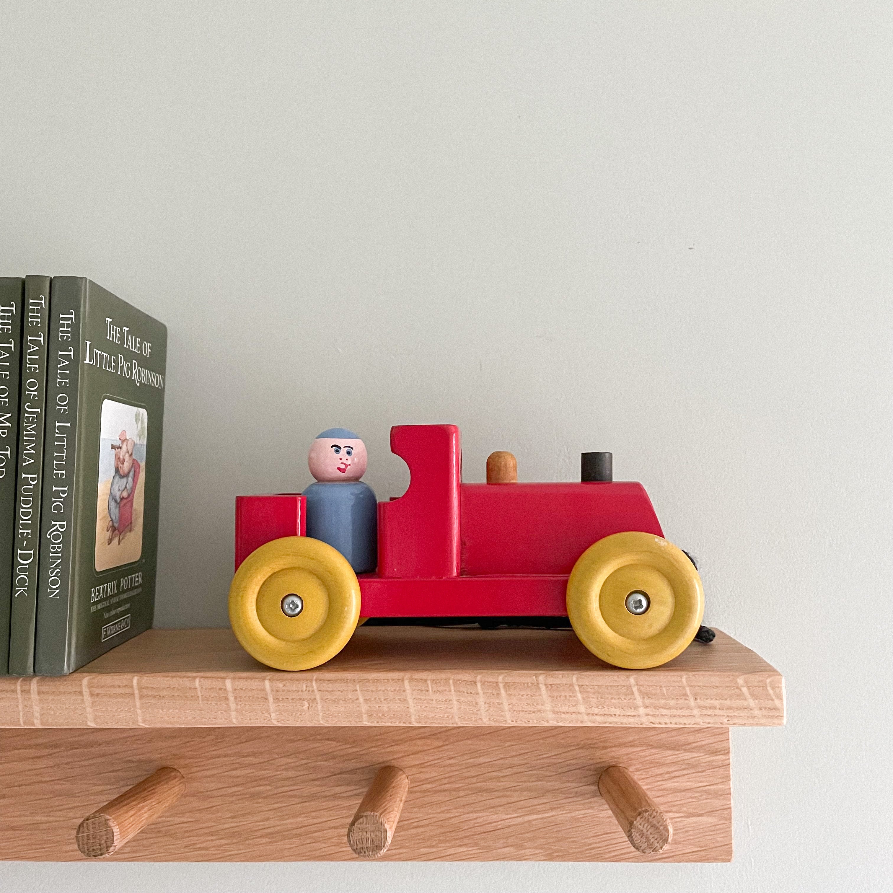 Vintage 1950s red wooden Escor train with peg-doll passenger, British made - Moppet