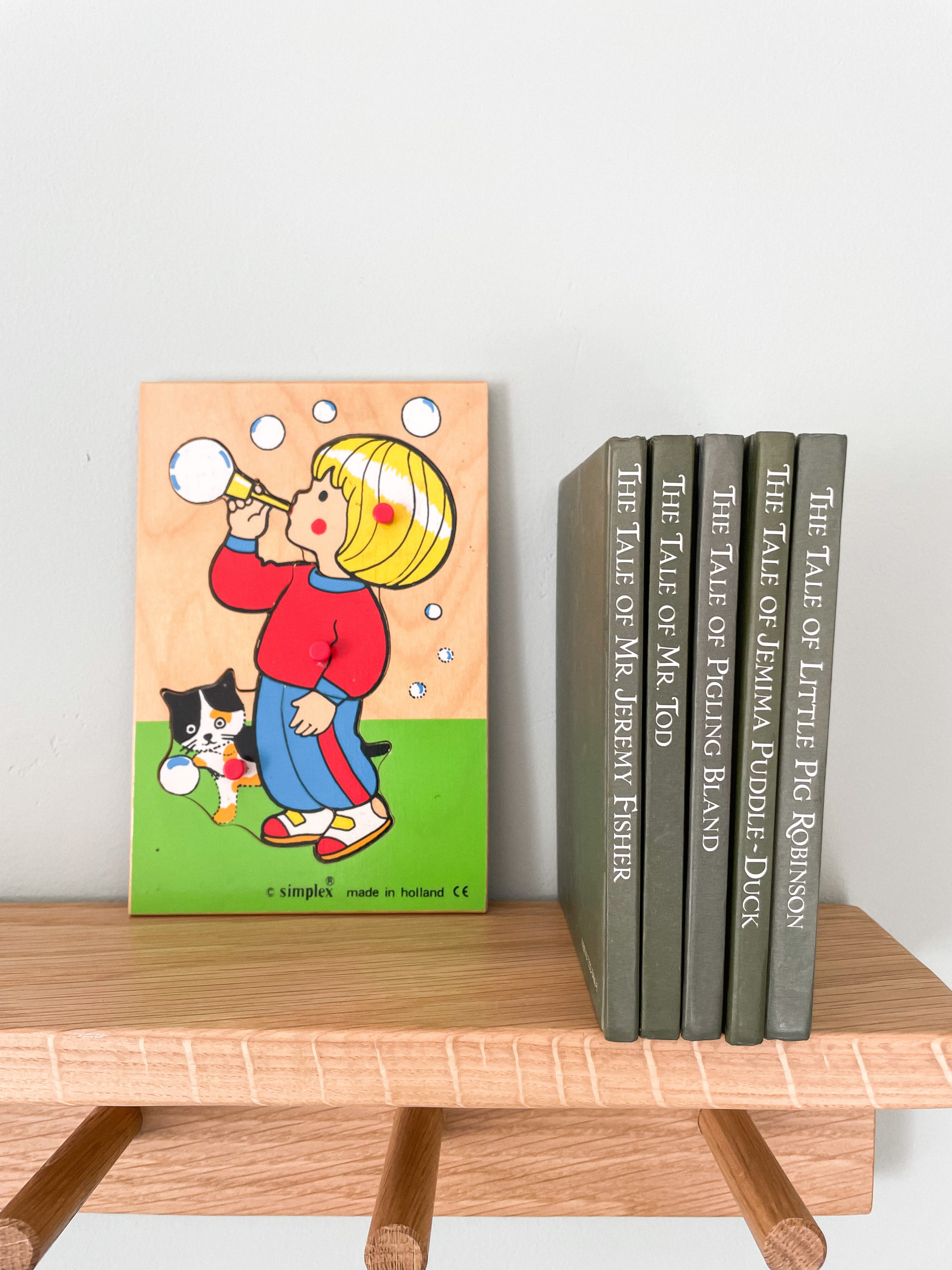 Vintage wooden jigsaw puzzle featuring a little girl blowing bubbles in bright primary colours, by Simplex of Holland - Moppet