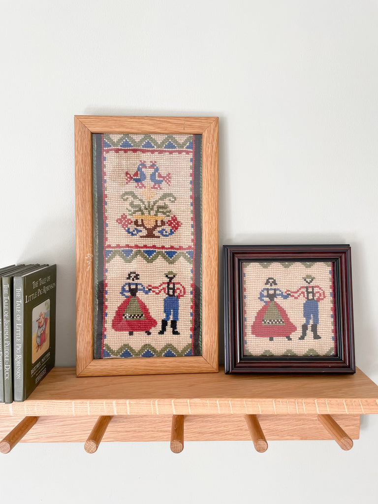 Pair of vintage framed embroideries featuring a European folk-art design of a dancing man and woman in traditional dress - Moppet