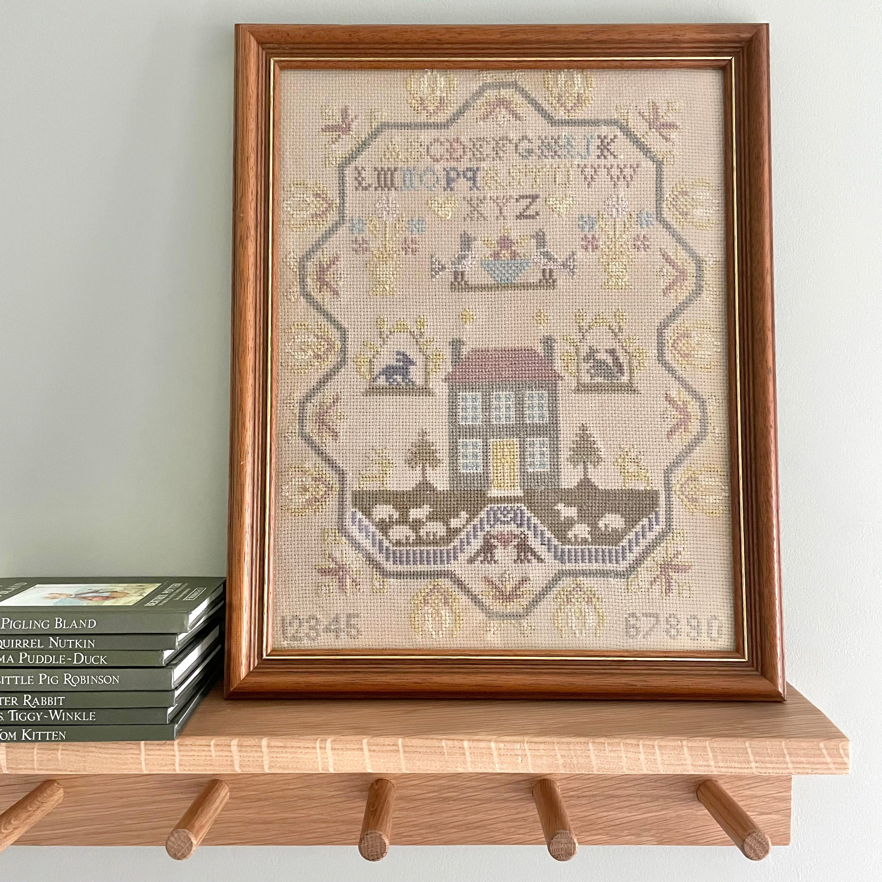Vintage framed cross stitch sampler of a house, alphabet, numbers and flock of sheep - Moppet