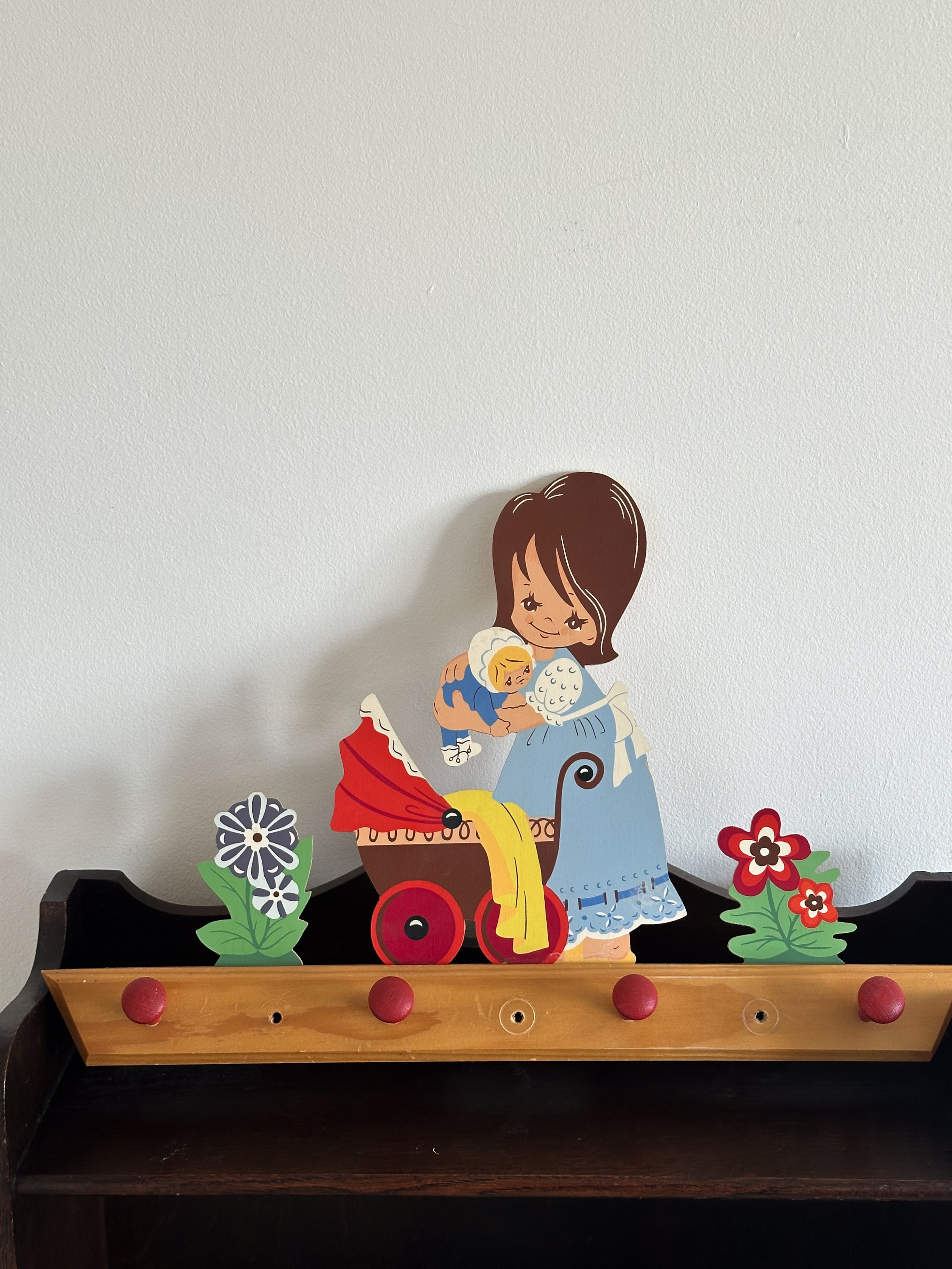 Vintage 1970s German wooden peg rail coat hooks with mother and baby design, made by Mertens Kunst in 1972