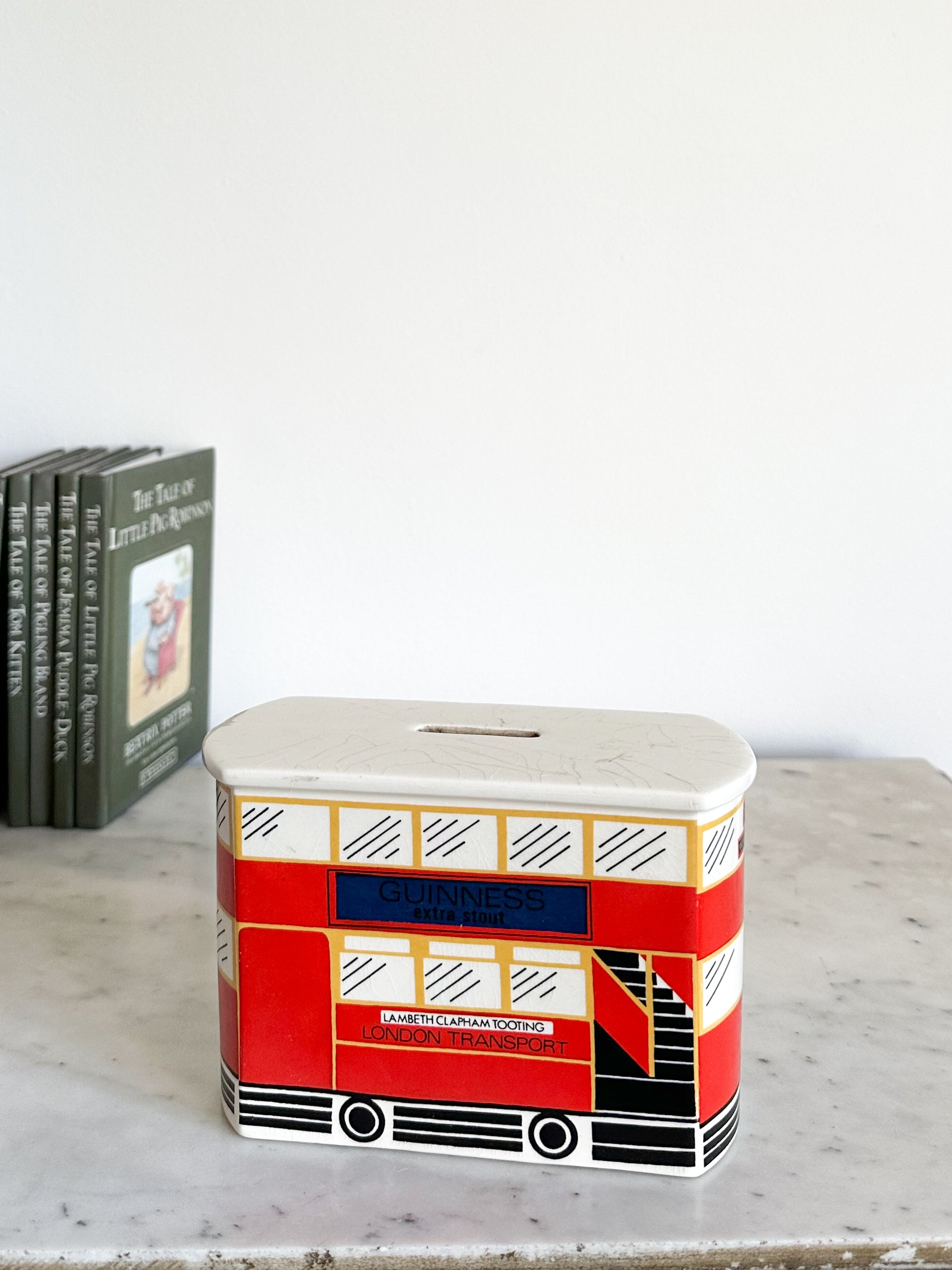 Vintage 1960s collectible double decker London bus with ‘Guinness’ advert piggy bank or money box, by Carlton Ware, made in England