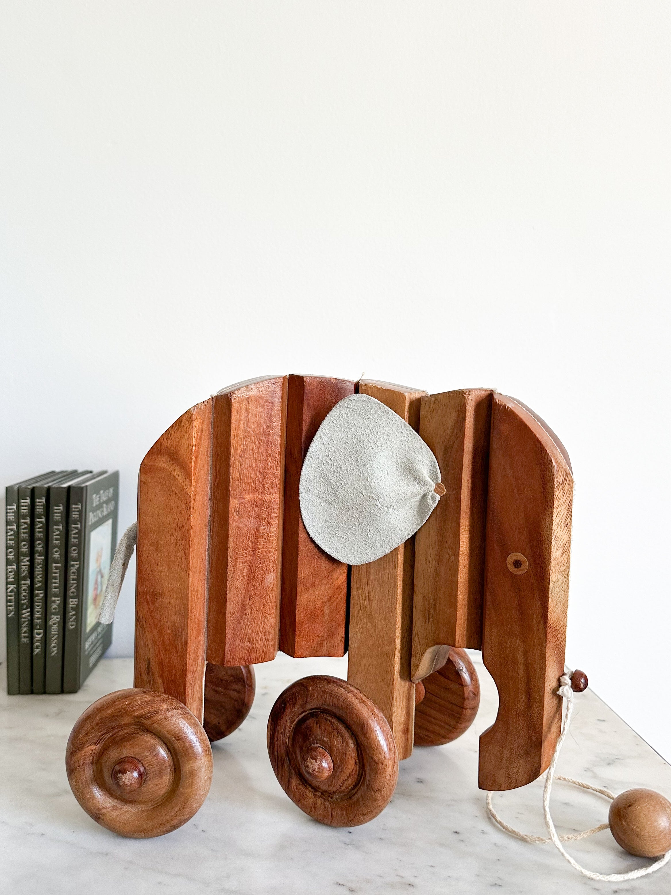 Vintage handmade wooden articulated pull-along elephant with leather ears