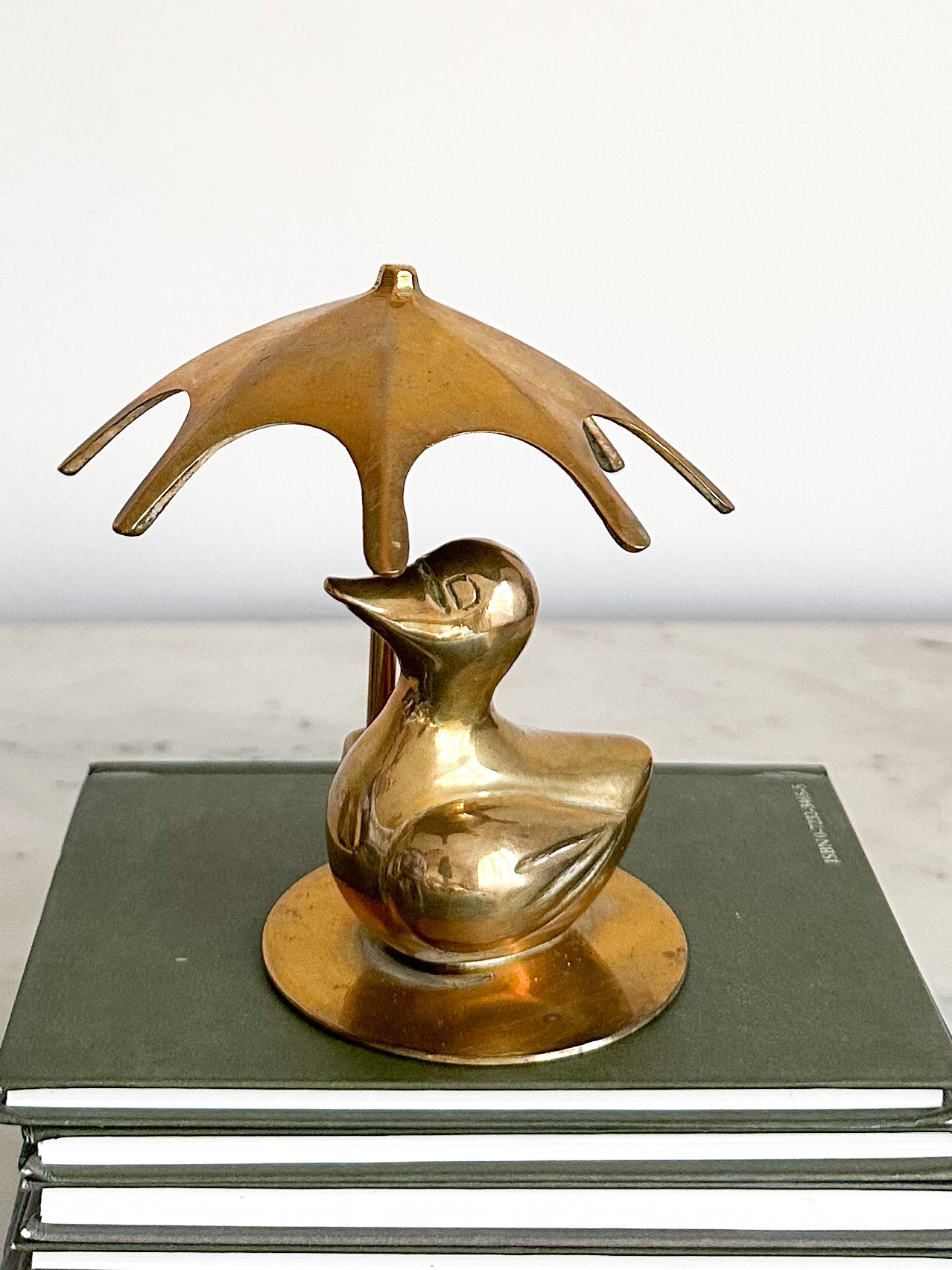Vintage brass duck with umbrella