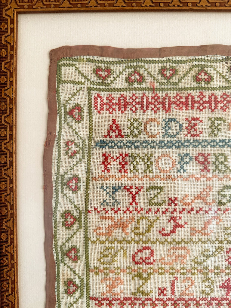 Antique framed alphabet cross stitch embroidery sampler, in blue, pink, green and yellow - Moppet