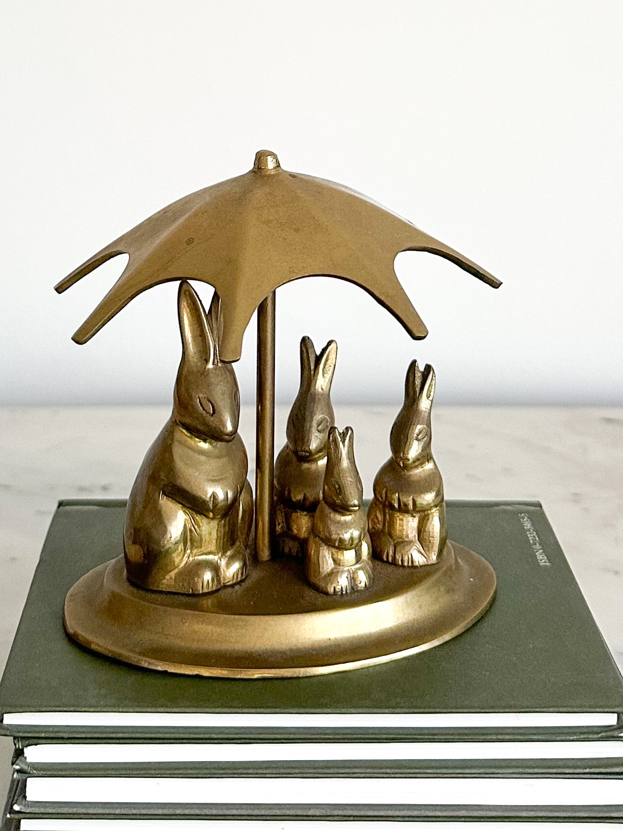 Vintage brass rabbit family with umbrella