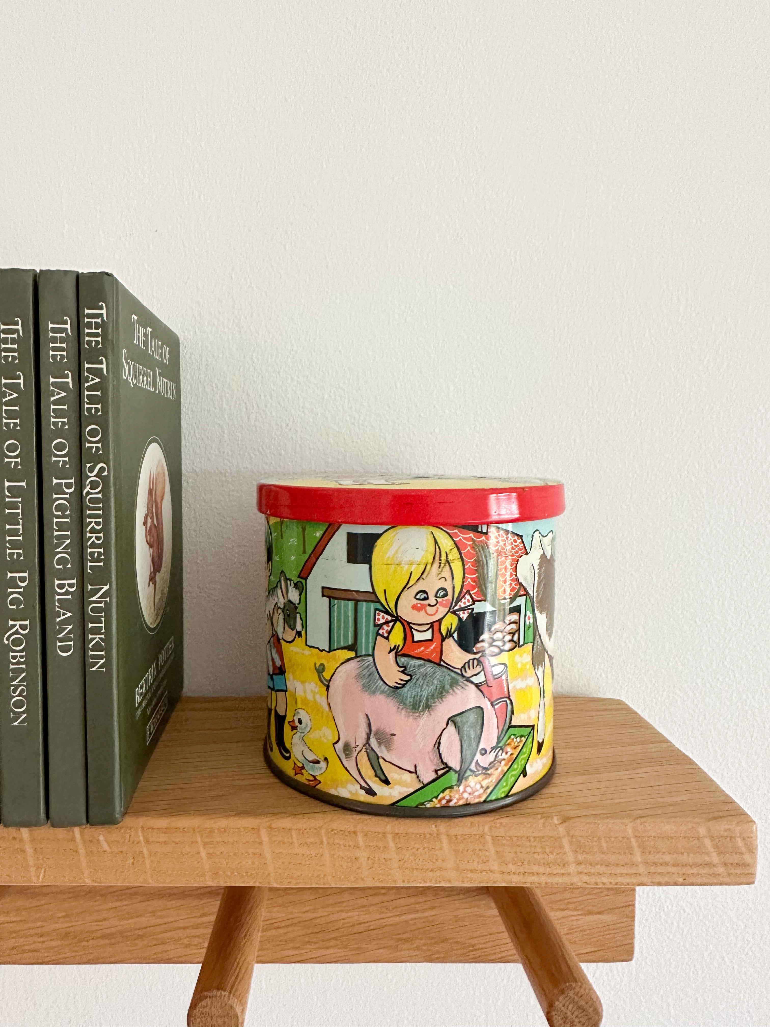 Vintage 1950s children’s illustrated graphic tin feat. girls and boys with farm animals, by Bluebird Toffee - Moppet