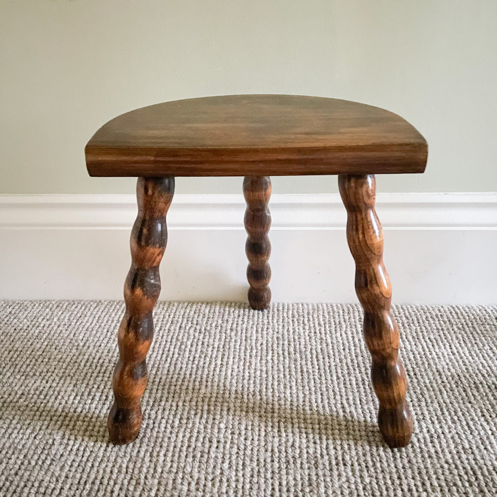 Vintage wooden French milking stool with three bobbin turned legs and a half-moon seat - Moppet