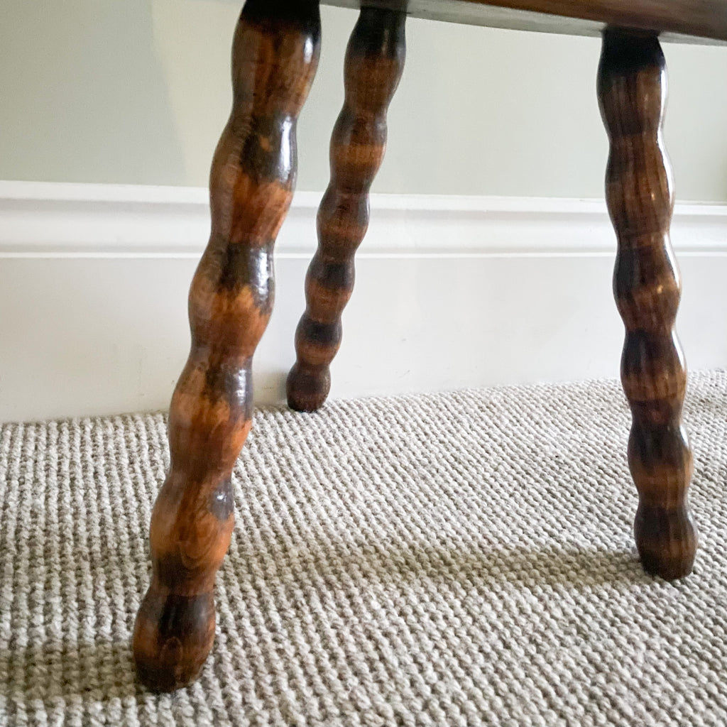 Vintage wooden French milking stool with three bobbin turned legs and a half-moon seat - Moppet