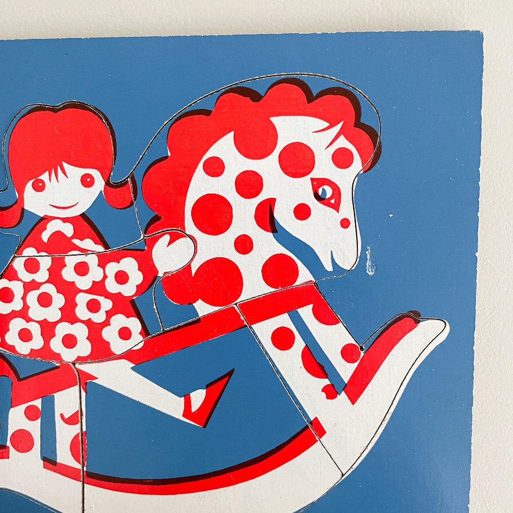 Vintage 1960/70s puzzle of a girl on a rocking horse in red, white and blue, by Tiger Toys - Moppet