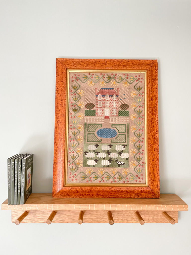 Vintage framed embroidery featuring a house with sheep and sheepdog in pastel colours - Moppet
