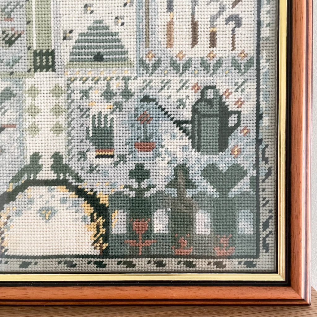 Vintage framed cross stitch of a garden in muted blues and greens - Moppet