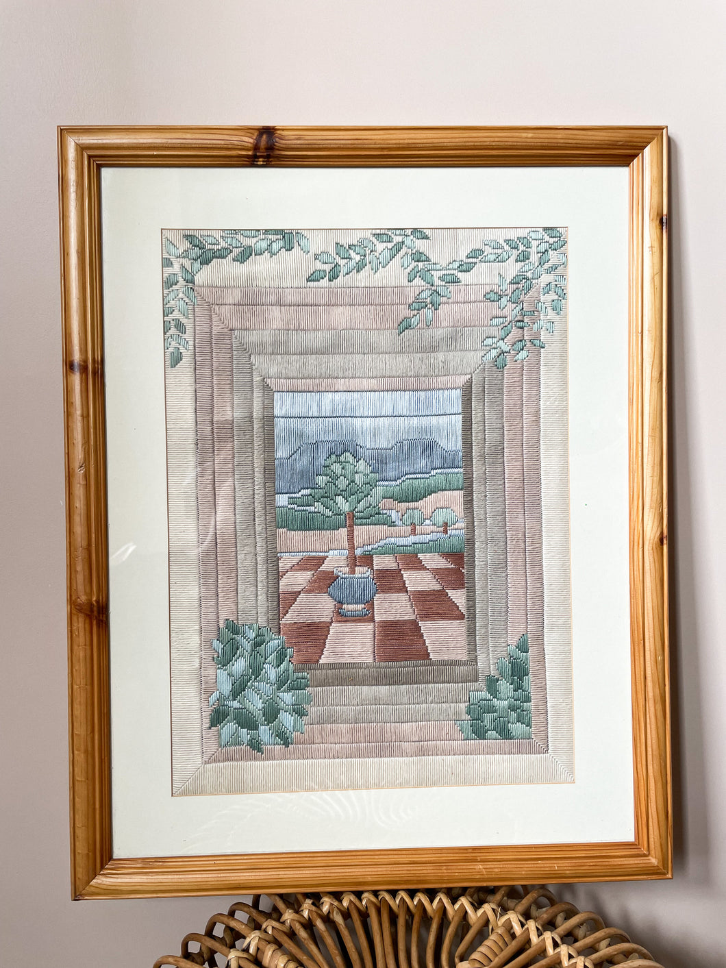 Vintage framed embroidery of a potted tree on a checkerboard patio - Moppet