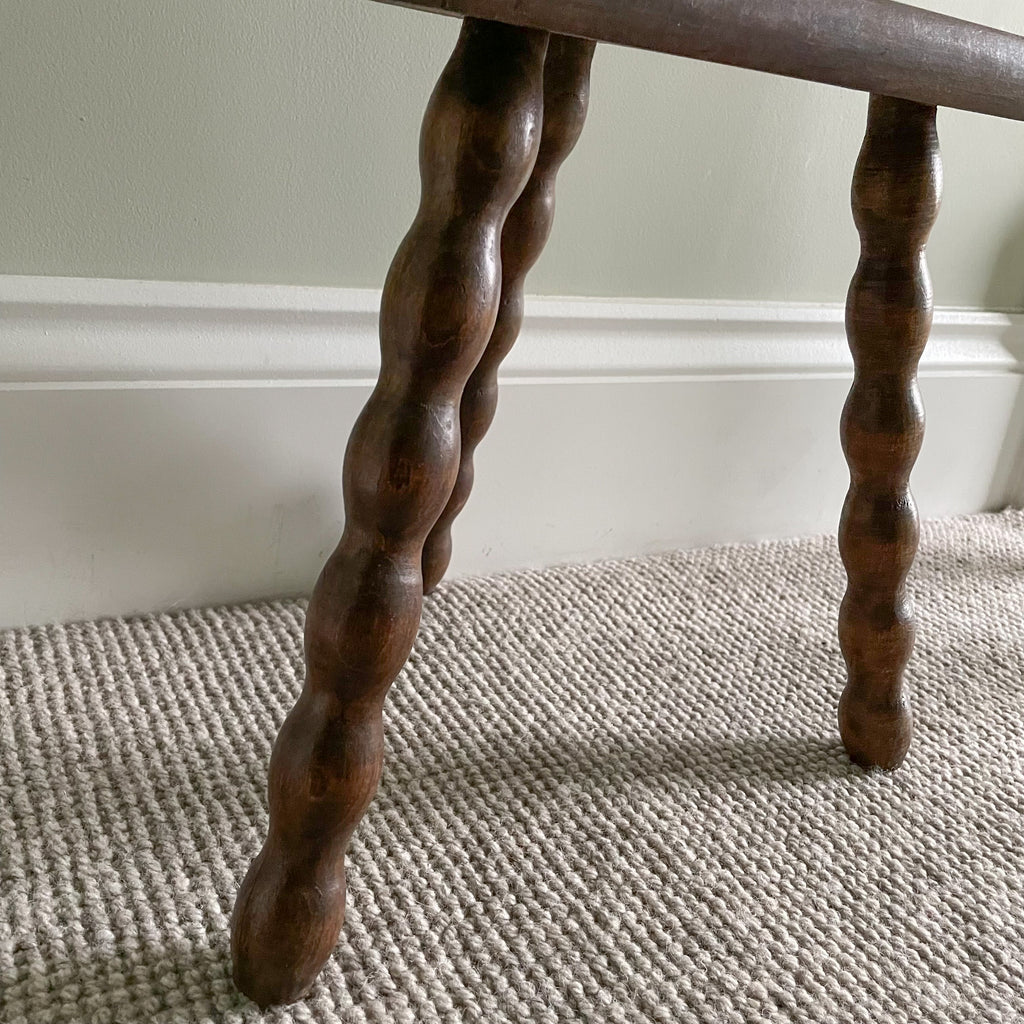 Vintage wooden French milking stool with three bobbin turned legs and a half-moon seat - Moppet