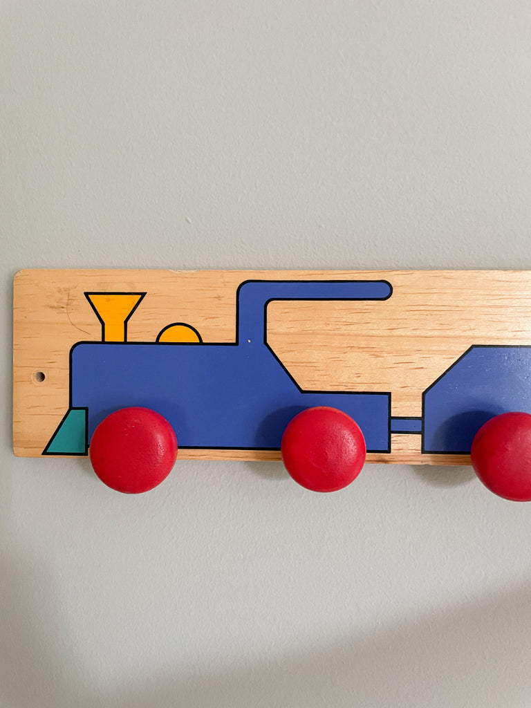 Vintage German wooden peg rail coat hook with hand-painted geometric train design - Moppet