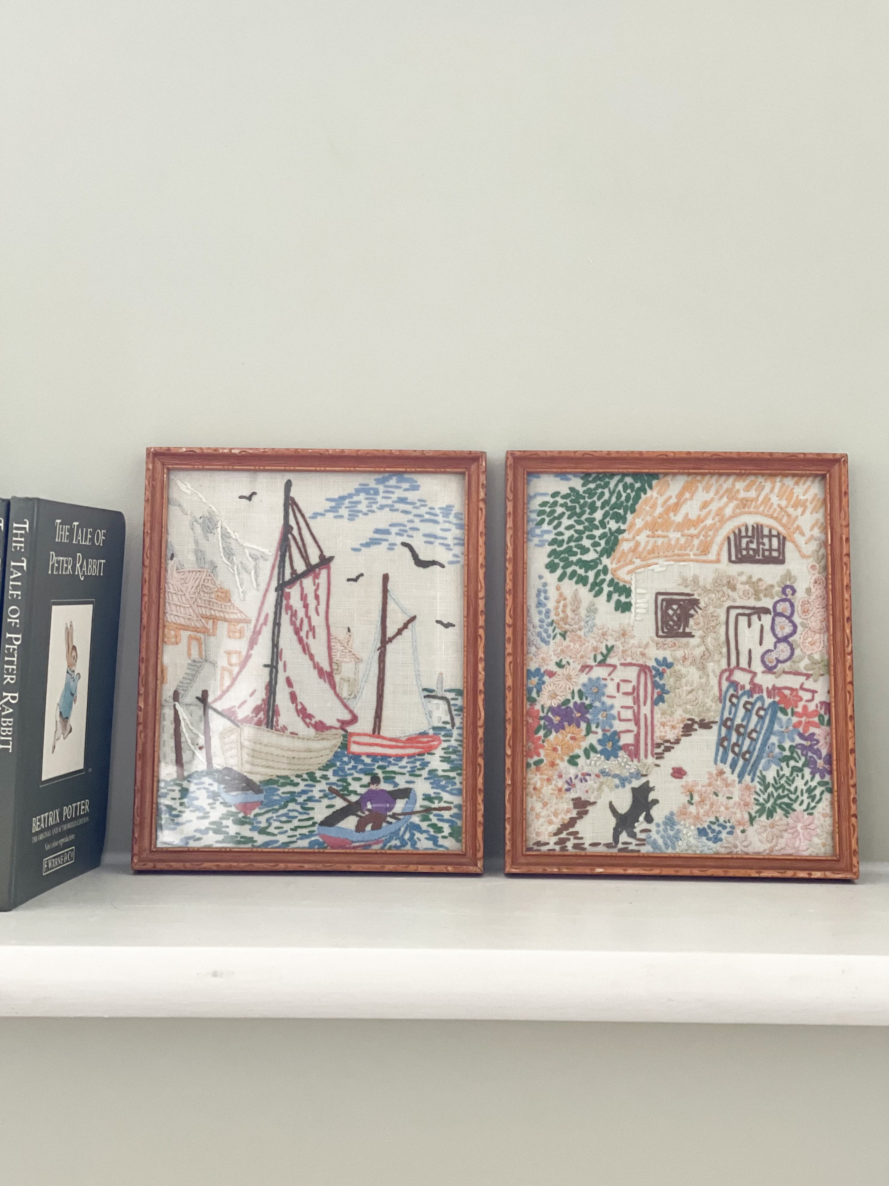 Pair of vintage framed embroideries in pastels, sailing boat and thatched cottage with cat - Moppet