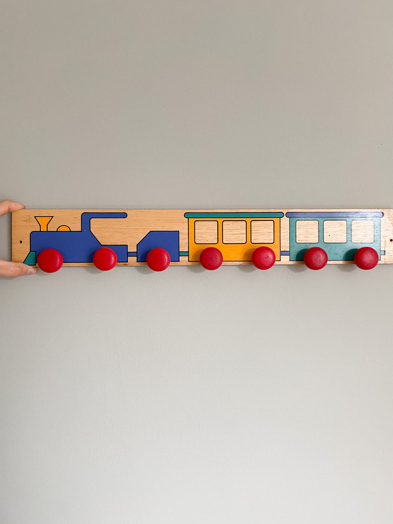 Vintage German wooden peg rail coat hook with hand-painted geometric train design - Moppet